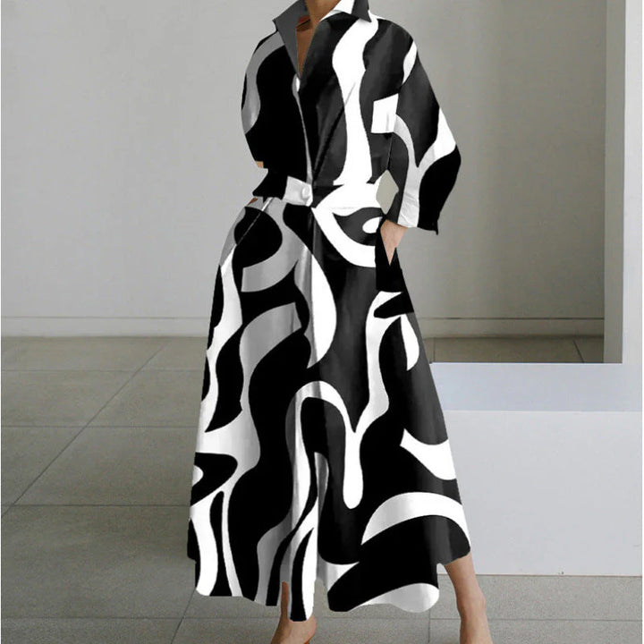 Model in newspaper print collared maxi dress showing movement and drape of flowing skirt