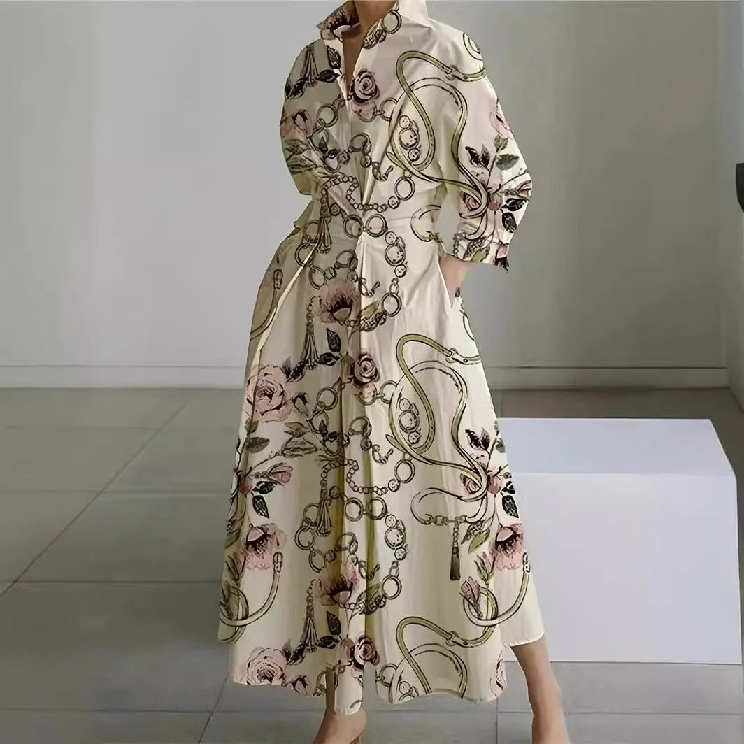Side profile of newspaper print maxi dress showing structured collar and long sleeve design