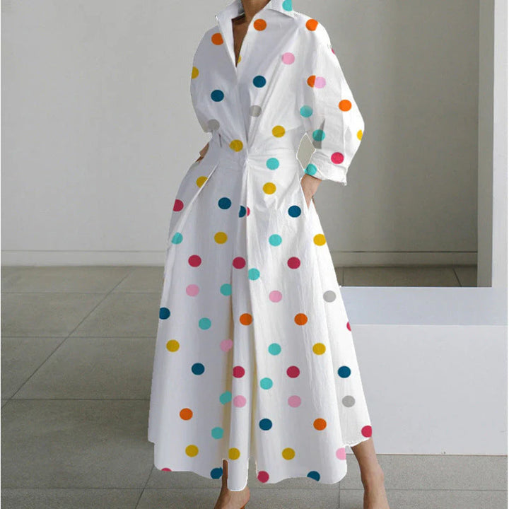 Detail shot of newspaper print maxi dress featuring bold yellow text blocks and long sleeves