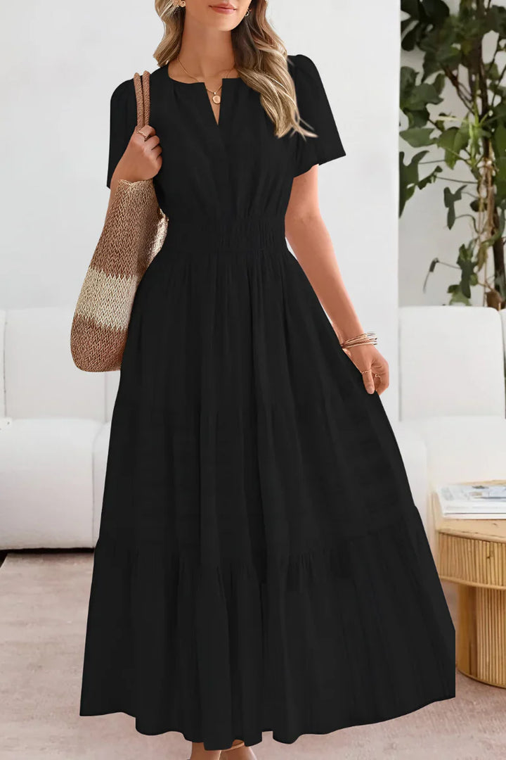 Close-up view of tiered midi dress showing textured stripe detail and relaxed A-line silhouette