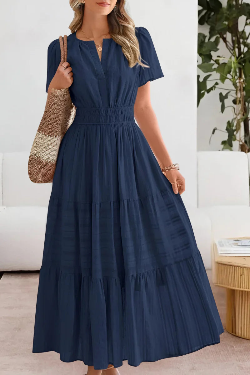 Side angle of tiered midi dress with short sleeves and three-tier skirt falling to midi length