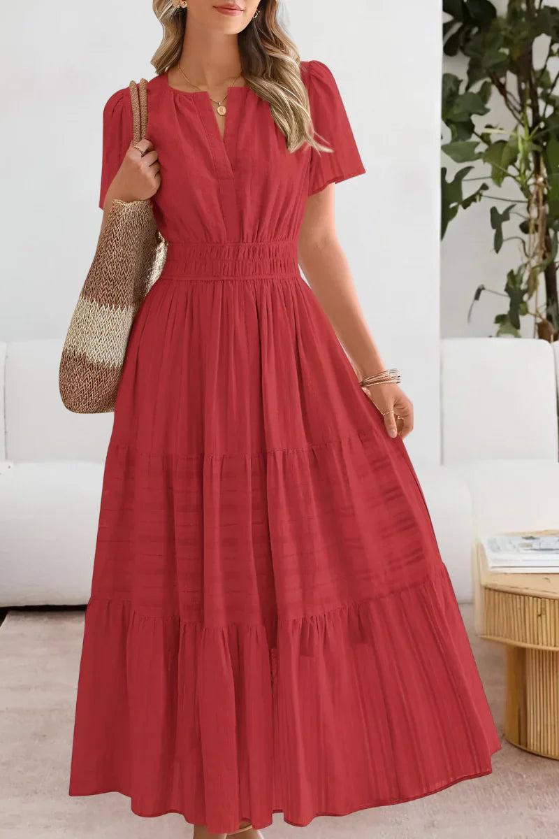 Back view of tiered midi dress displaying gathered waist and flowing A-line shape