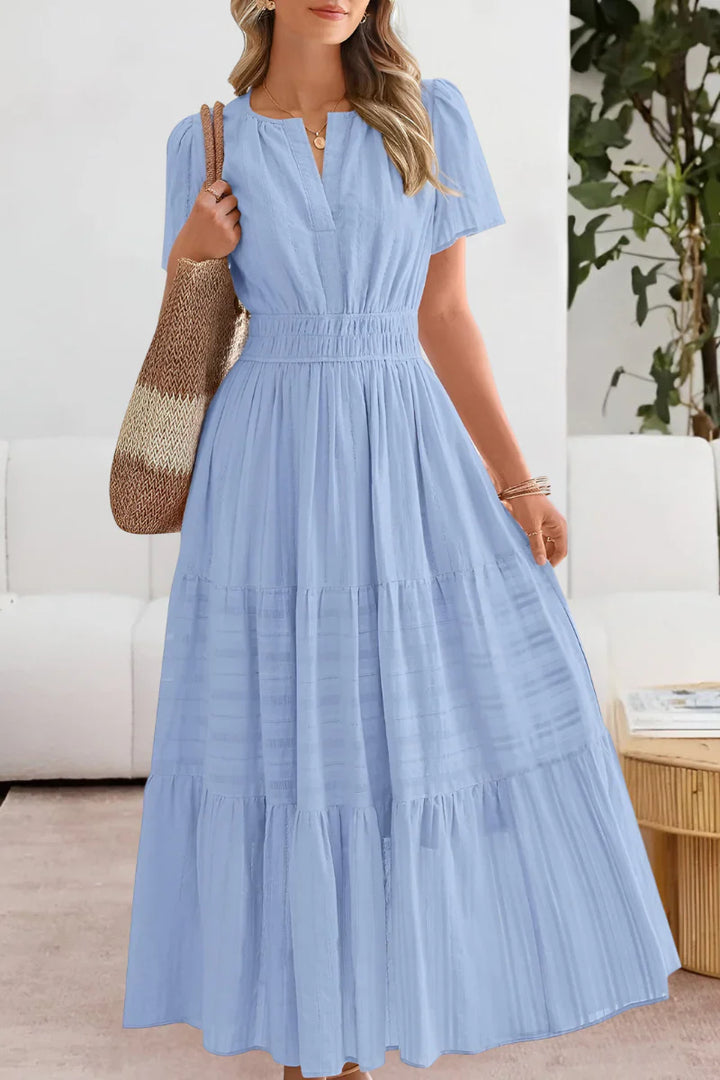 Tiered midi dress fabric detail showing soft woven construction and textured stripe pattern