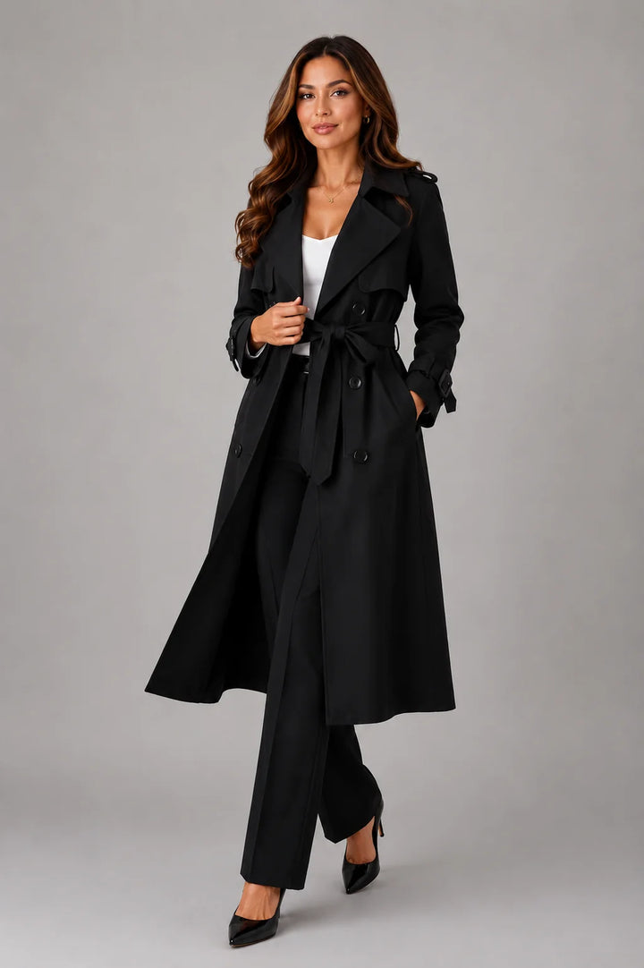 Close-up of double-breasted button detail and adjustable belt on women's trench coat