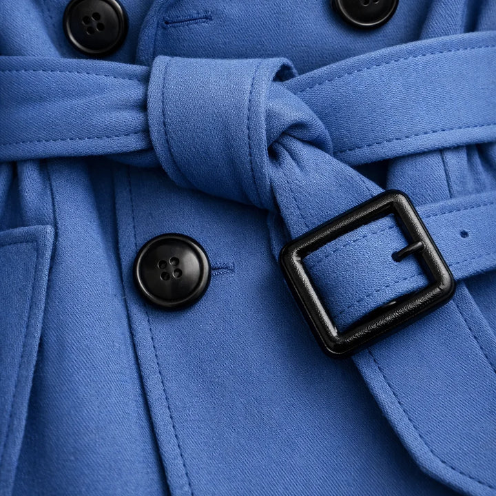 Detail of buckled cuff and sleeve finish on classic beige trench coat