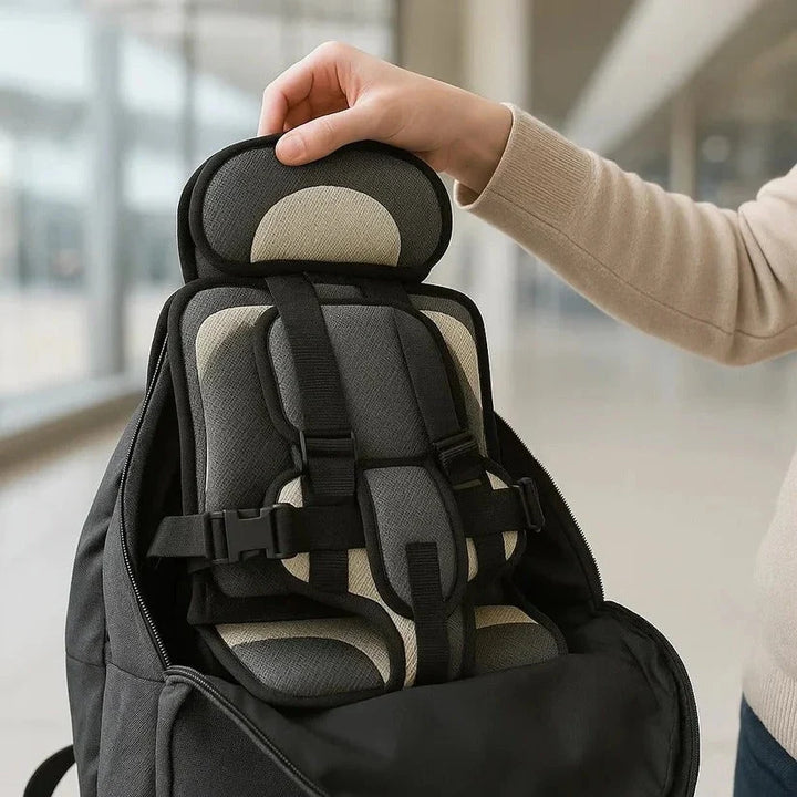 Portable car seat with blue padded support and black harness straps providing secure positioning for young children