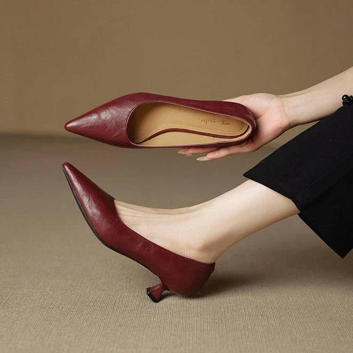 Close-up of pointed-toe leather heels showing smooth burgundy leather upper and artisan-crafted construction