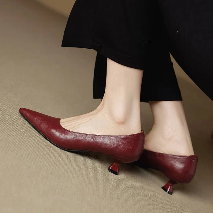 Women's leather heels in burgundy styled with black tailored trousers for smart-casual elegance