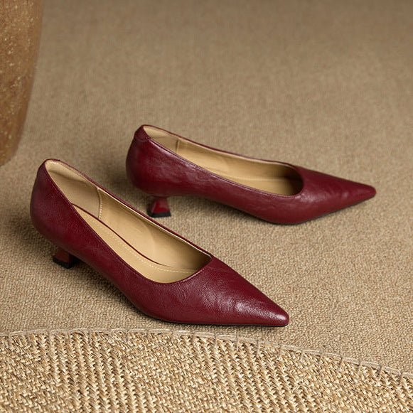 Pointed-toe heels in burgundy leather with streamlined silhouette for office and evening wear