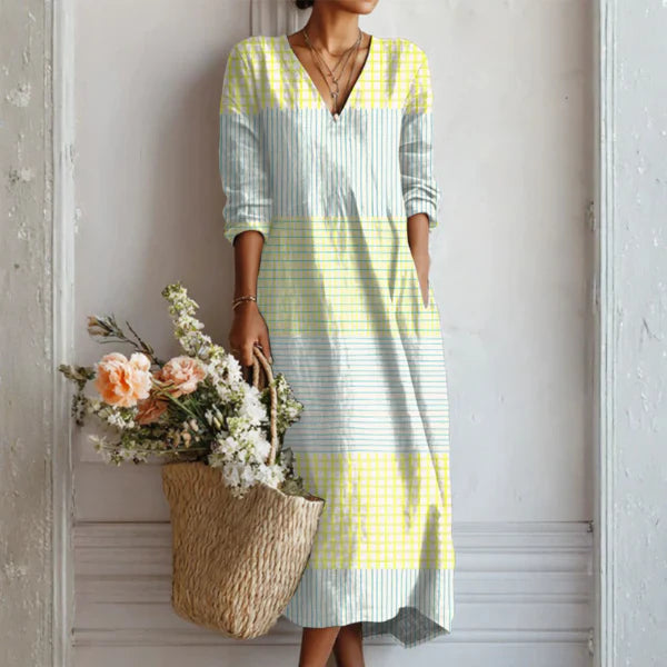 Charlotte wearing the Elegant Crisp Summer Dress in yellow and blue stripes with V-neckline and three-quarter sleeves