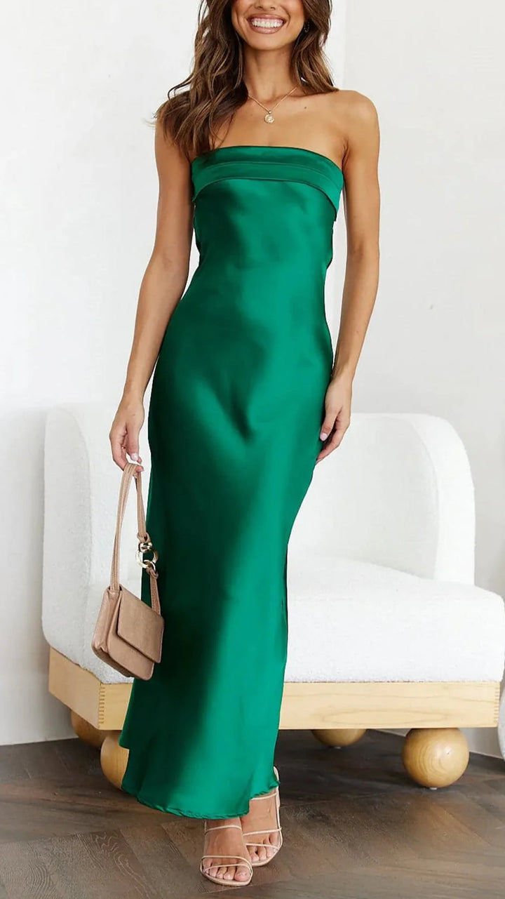 Woman posing in strapless satin midi dress demonstrating elegant drape and flattering silhouette