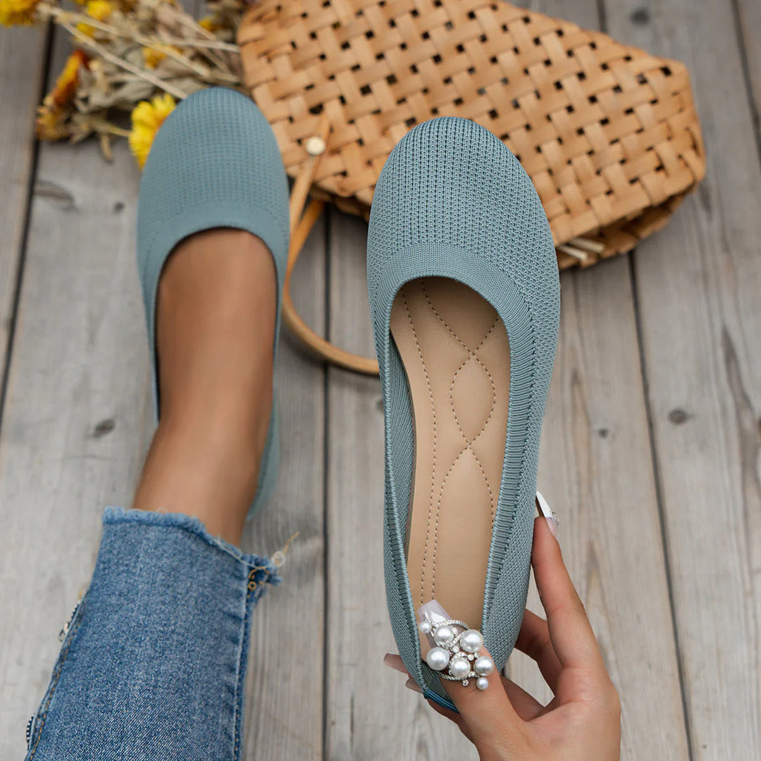 Close-up of women's knit flats displaying ribbed pattern and smooth interior lining