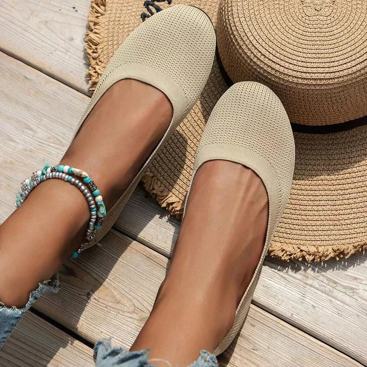 Detail of women's slip-on flats highlighting breathable knit upper and cushioned construction