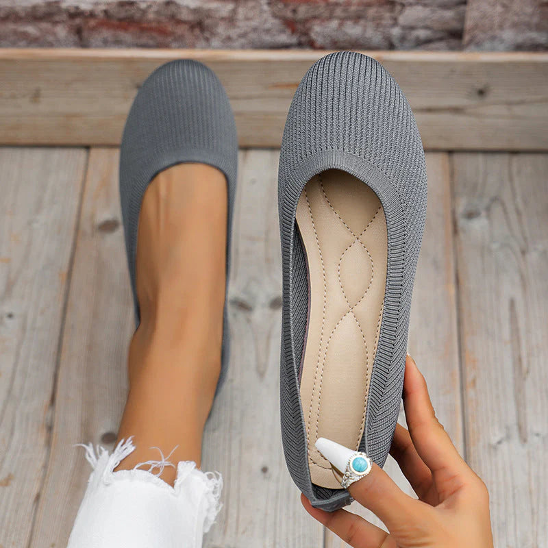 Overhead view of women's ribbed knit flats in grey with slip-resistant rubber outsole