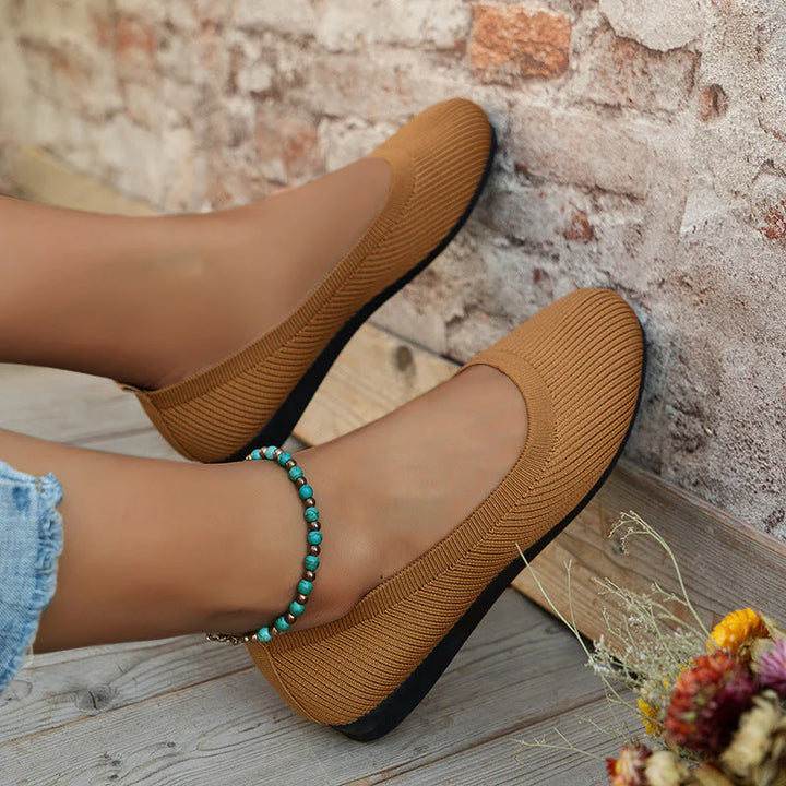 Full view of women's ribbed knit flats in grey showing arch support and casual silhouette