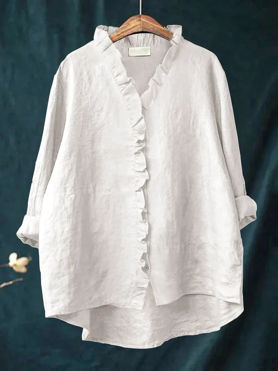 Close-up view of ruffle trim detail along v-neckline and button placket on women's casual blouse