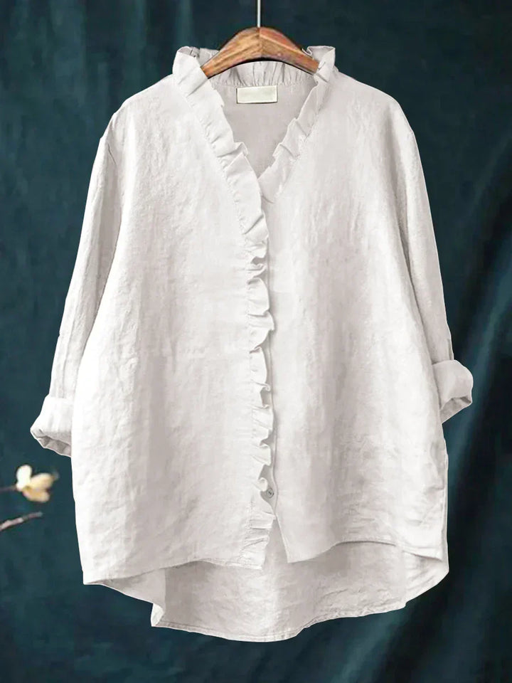 Close-up view of ruffle trim detail along v-neckline and button placket on women's casual blouse