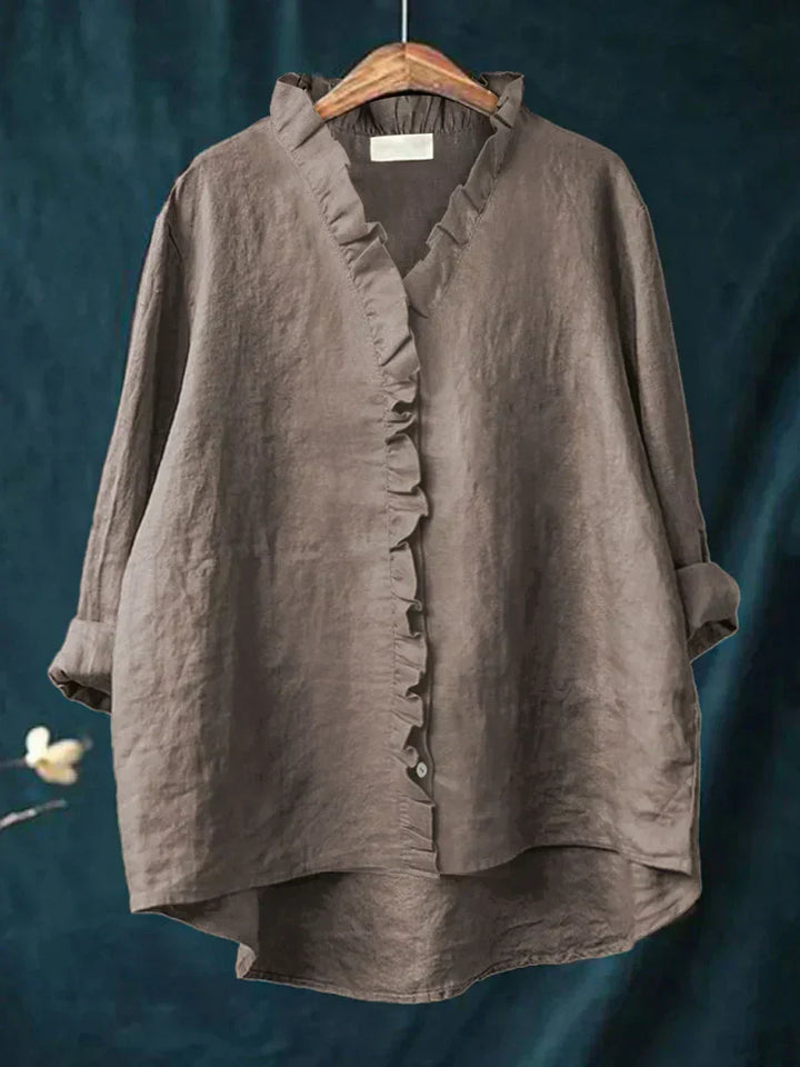 Side profile of relaxed fit blouse showing flowing silhouette and curved hemline for everyday wear