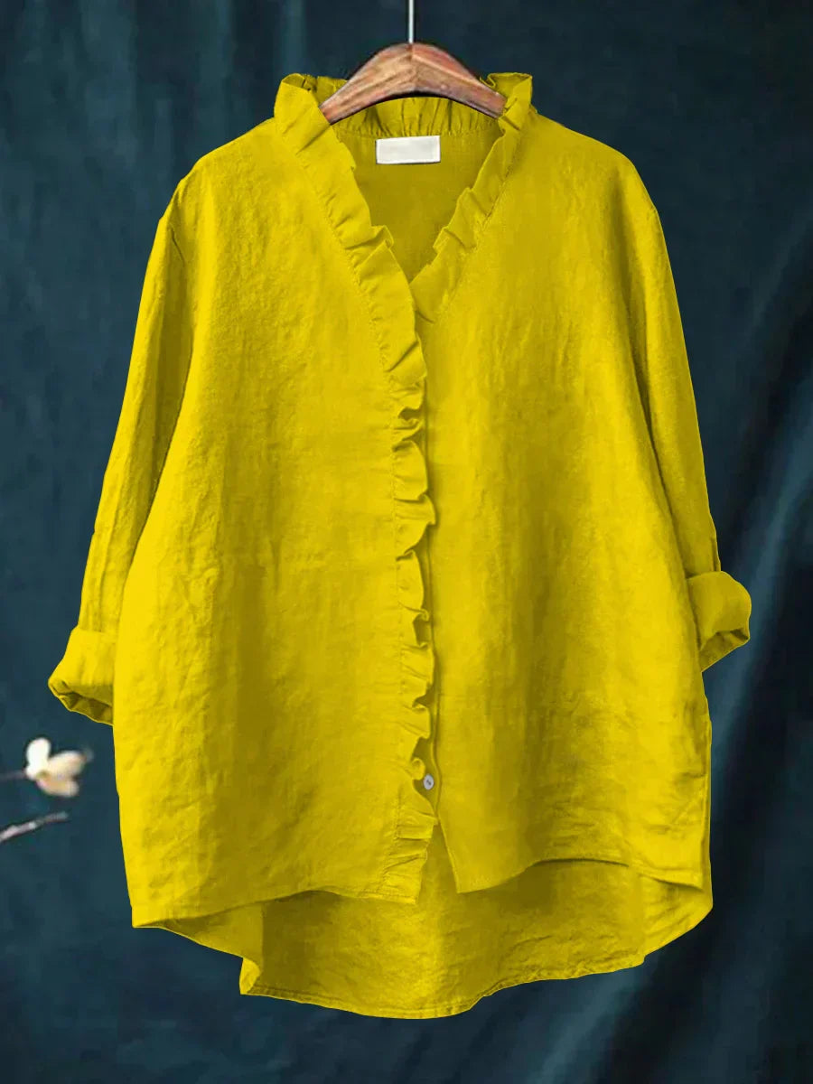 Women's blouse with roll-tab cuffs on three-quarter sleeves and textured woven fabric construction