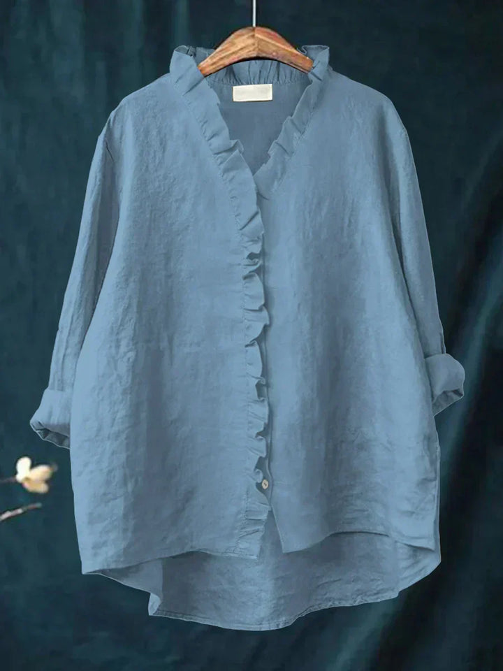 Full front view of v-neck blouse featuring feminine ruffle accents and button-through front closure