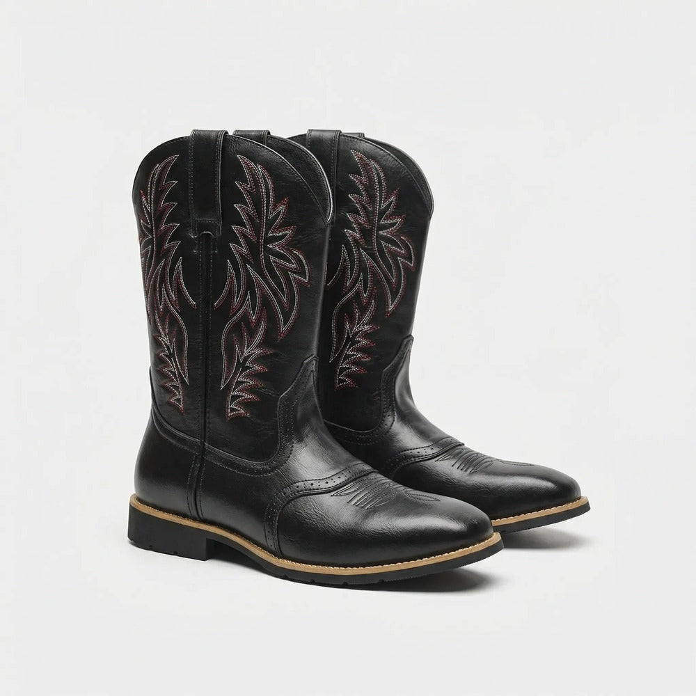 Claude black cowboy-style boots, side view showing stitched detail