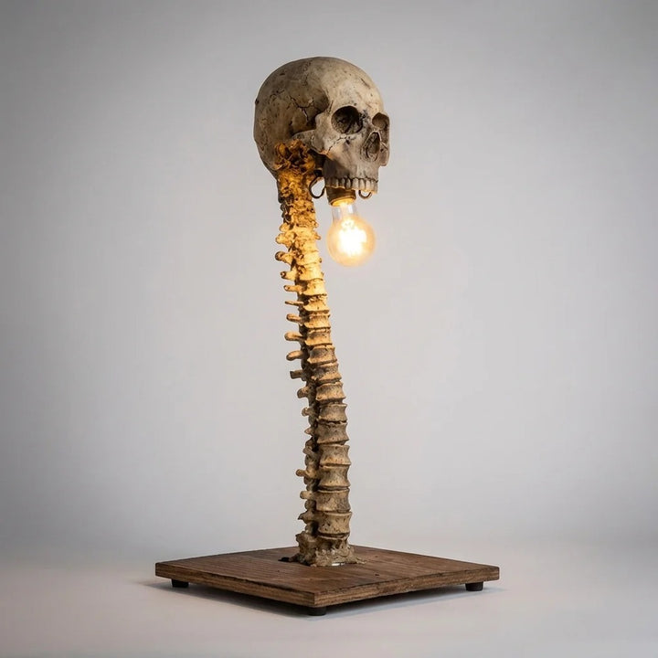 Decorative Skull Table Lamp front view showing the spine base and hanging bulb