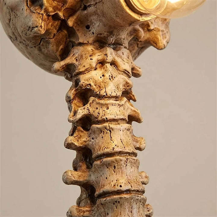 Close-up detail of the textured spine and skull base of the Decorative Skull Table Lamp