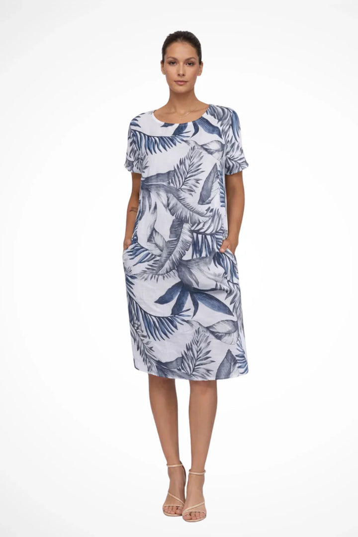 Front view of relaxed shift dress featuring all-over botanical leaf print and side pockets