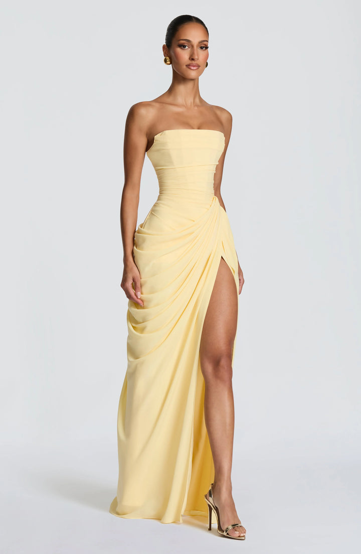 Close-up of pleated bodice detailing on strapless maxi dress with lace-up back
