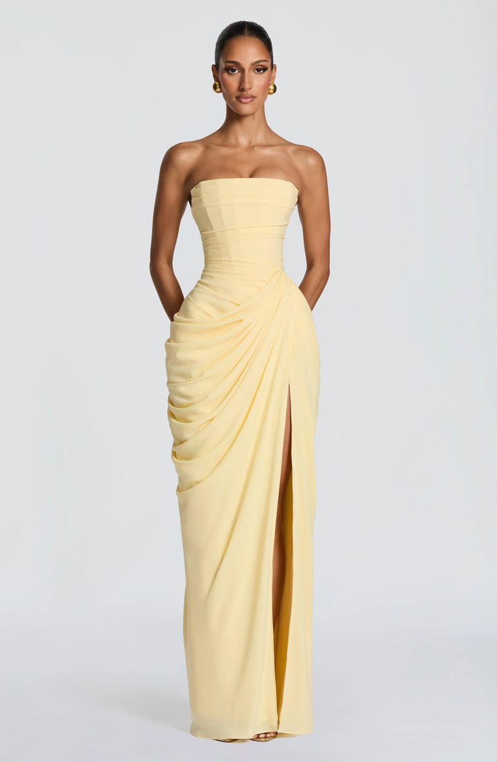 Model wearing strapless maxi dress showing structured fit and flowing fabric drape