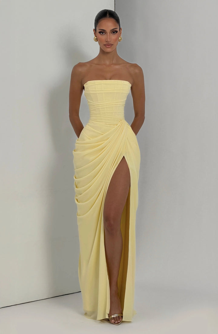 Strapless maxi dress in motion showing leg split and draped waist design