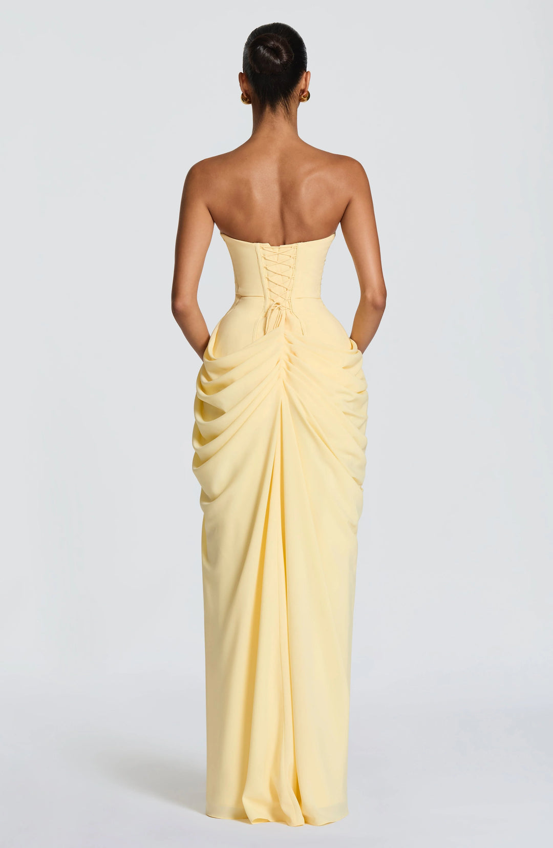 Rear view of strapless maxi dress with lace-up back and flowing skirt