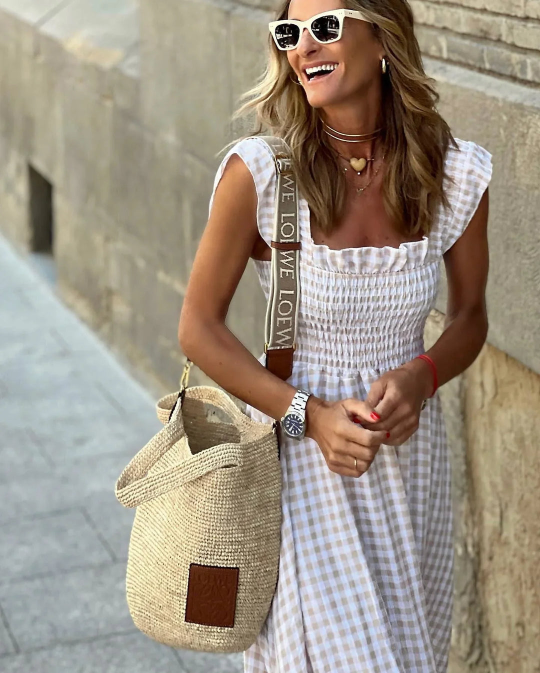 Back view of the gingham maxi dress showing the flowing silhouette and full-length design