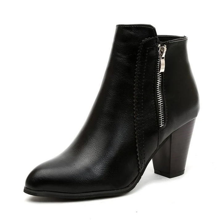 Pair of women's zip-up ankle boots showing structured silhouette and heel design