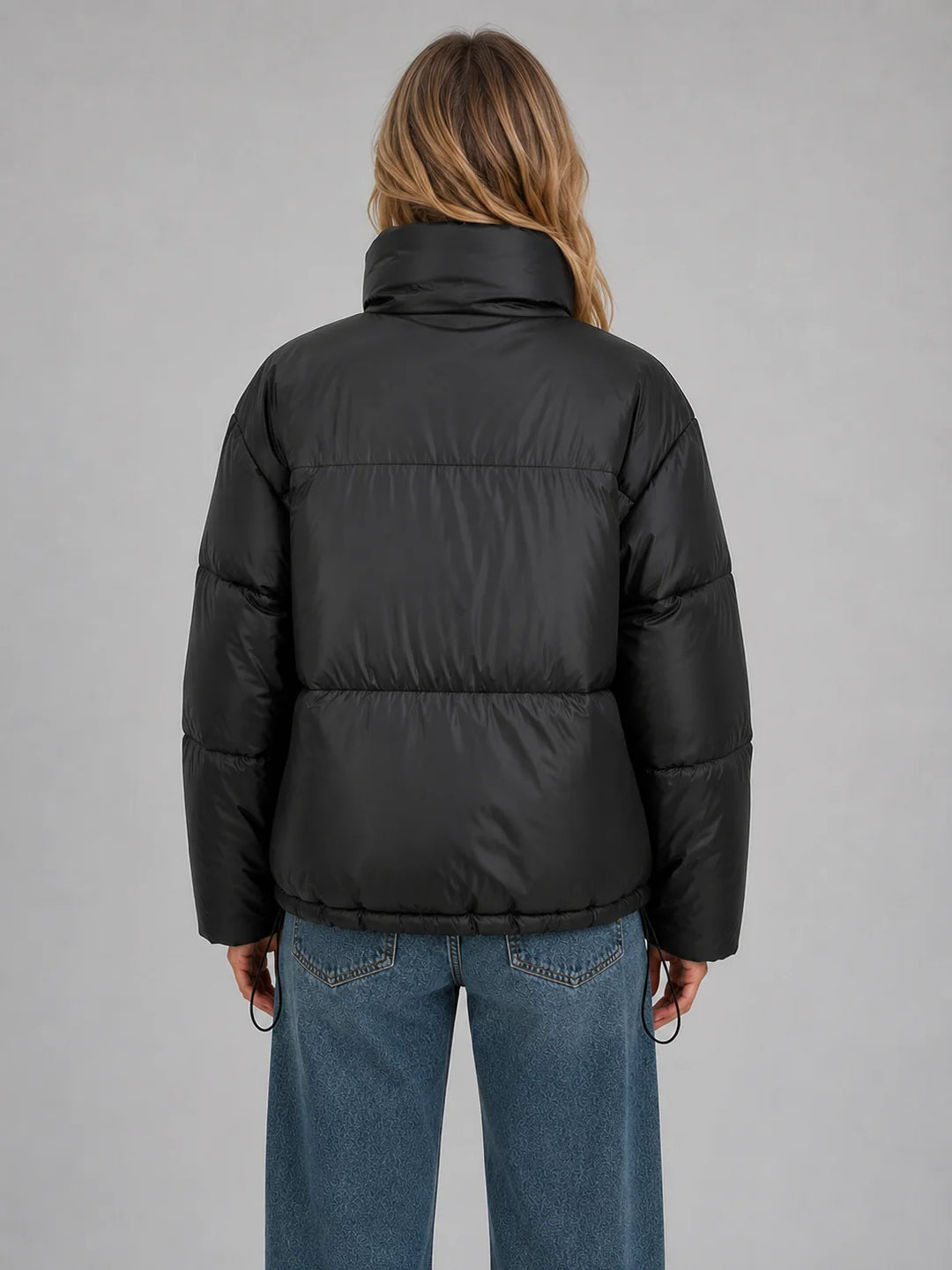 Front view of cropped puffer jacket with high stand collar and full zip fastening for women