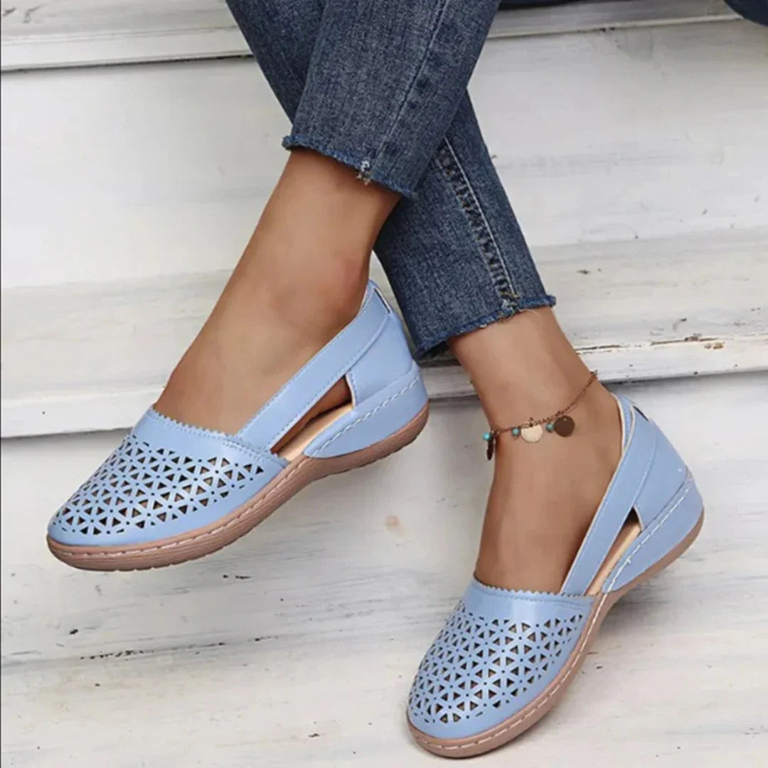 Women's breathable flats in blush pink with geometric cut-out pattern across vamp and closed-toe silhouette