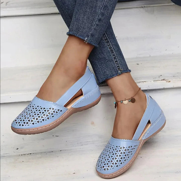 Women's breathable flats in blush pink with geometric cut-out pattern across vamp and closed-toe silhouette