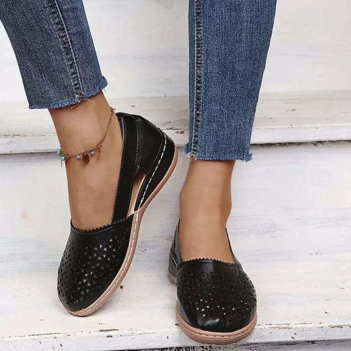 Women's perforated flats styled with cropped jeans, highlighting slip-on design and supportive footbed