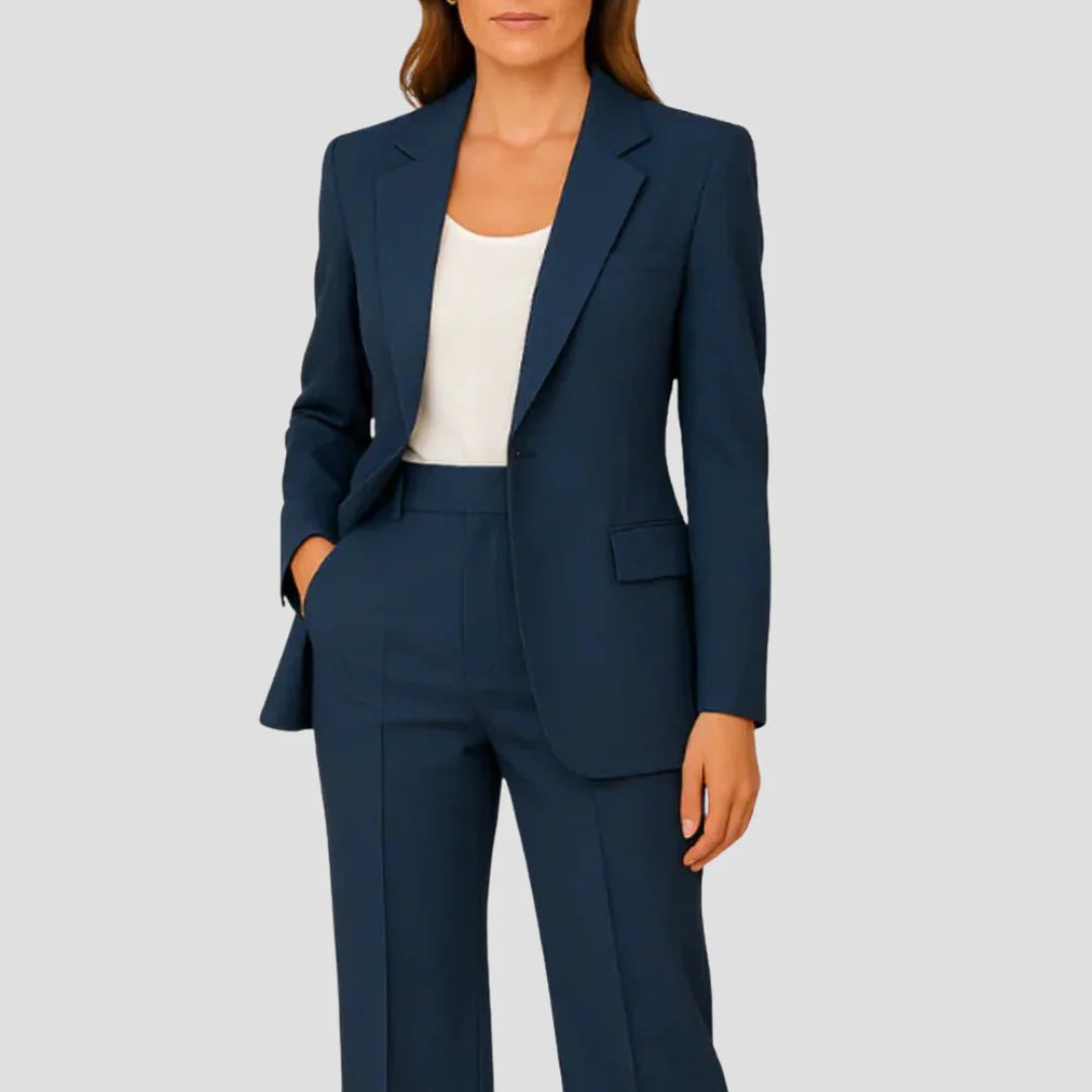 Side view of women's beige two-piece suit showing structured blazer fit and straight-leg trouser silhouette