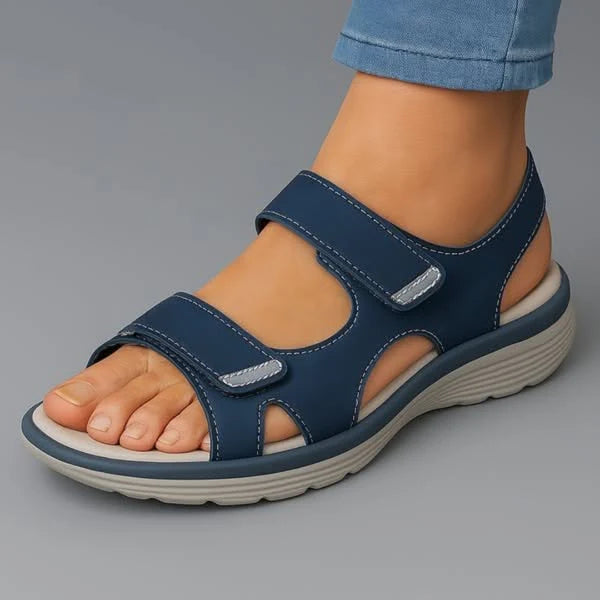 Women's walking sandals in navy with dual adjustable hook-and-loop straps and cushioned footbed shown on foot