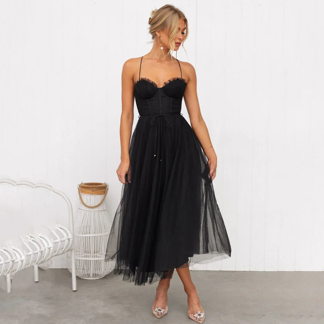 Detail of layered tulle midi skirt with soft drape and mid-calf length hem