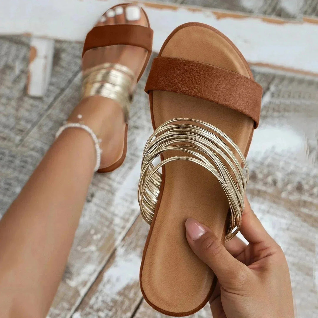 Side angle of women's arch support sandals featuring slingback elastic and flat sole construction for all-day wear