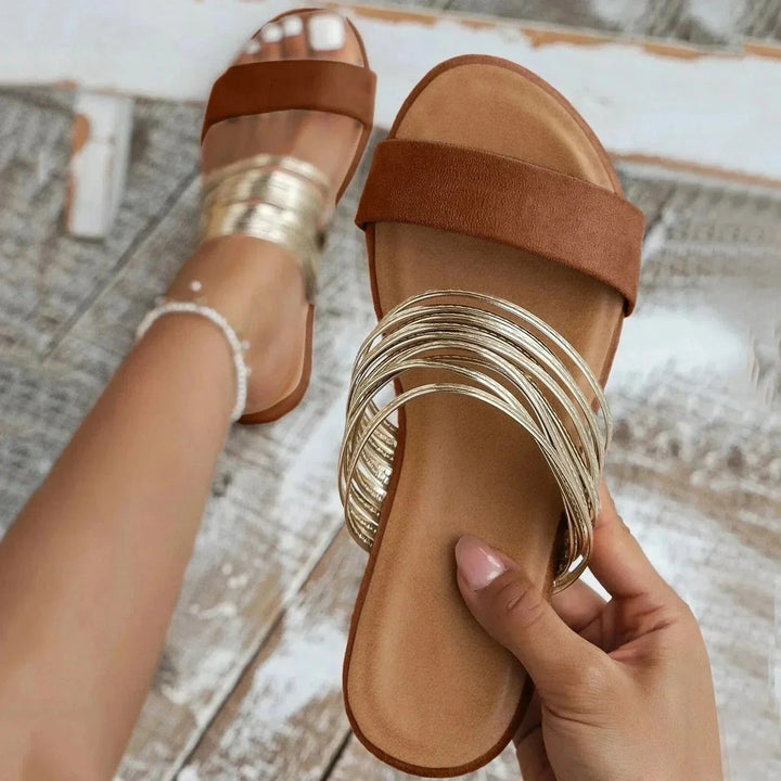 Side angle of women's arch support sandals featuring slingback elastic and flat sole construction for all-day wear