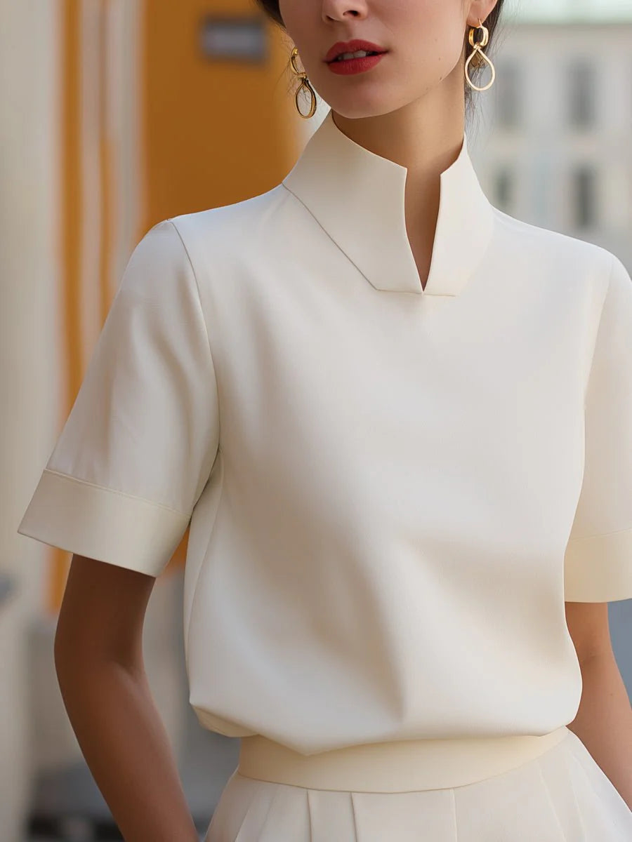 Close-up view of women's stand collar blouse showing structured neckline and clean tailored lines