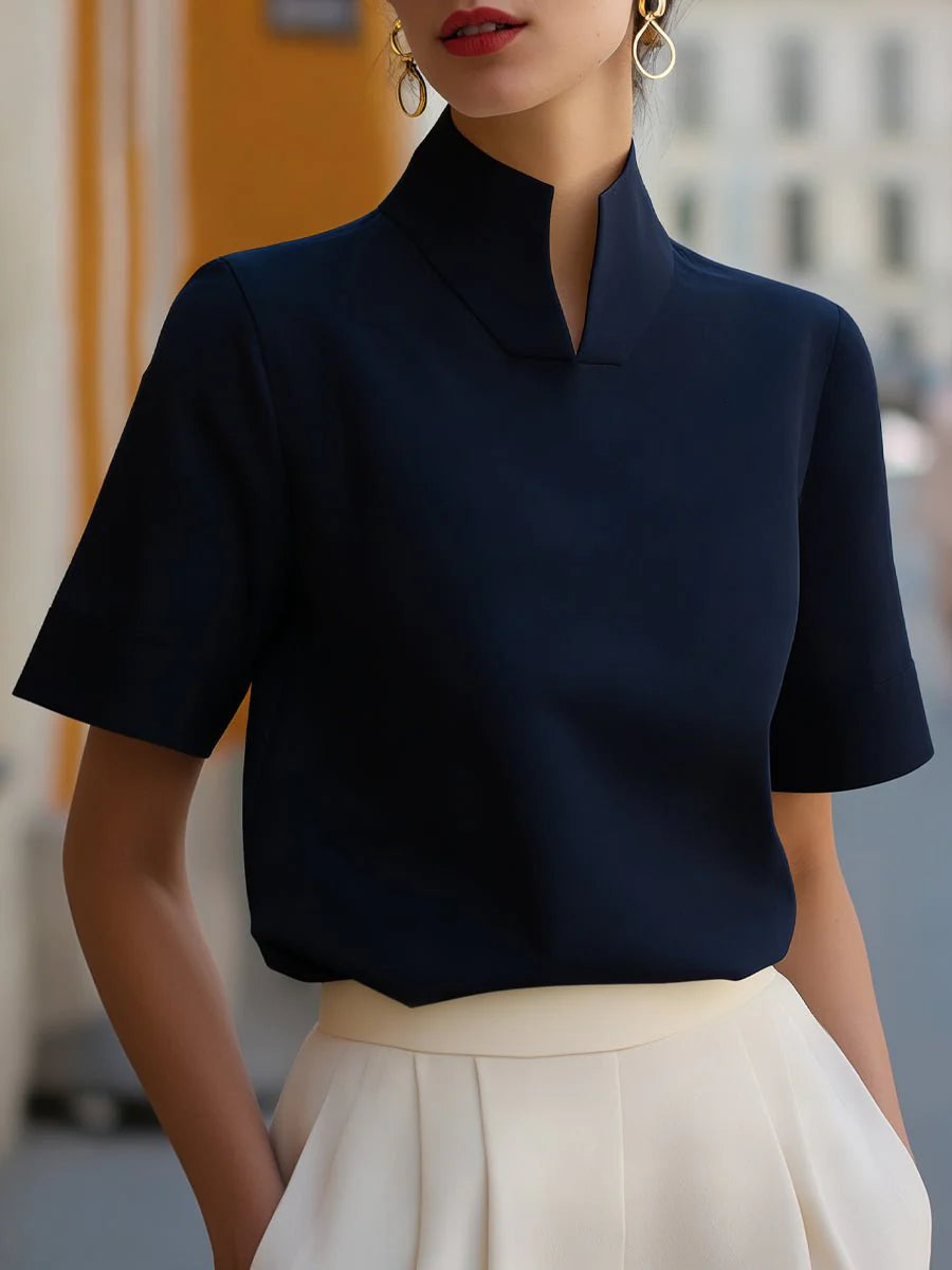 Back view of women's stand collar short sleeve blouse showing clean construction