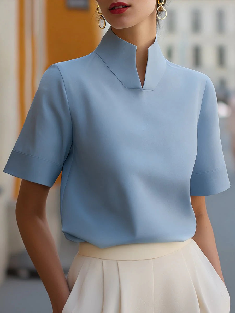 Women's tailored blouse with stand collar styled for professional office wear