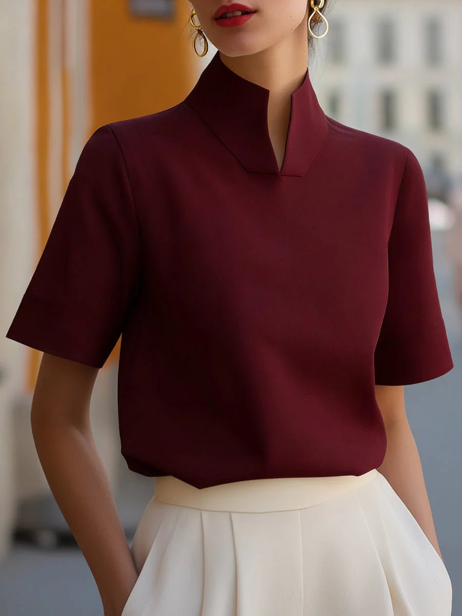 Full-length view of women's stand collar blouse with short sleeves and refined silhouette