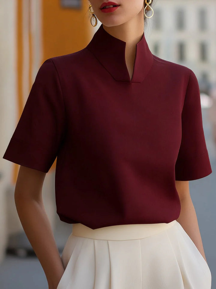 Full-length view of women's stand collar blouse with short sleeves and refined silhouette