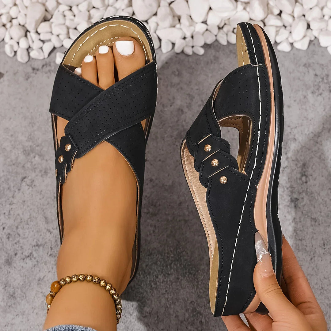 Women's wedge sandals showing cushioned footbed construction and supportive arch design