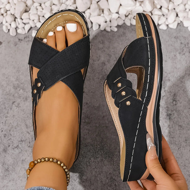 Women's wedge sandals showing cushioned footbed construction and supportive arch design